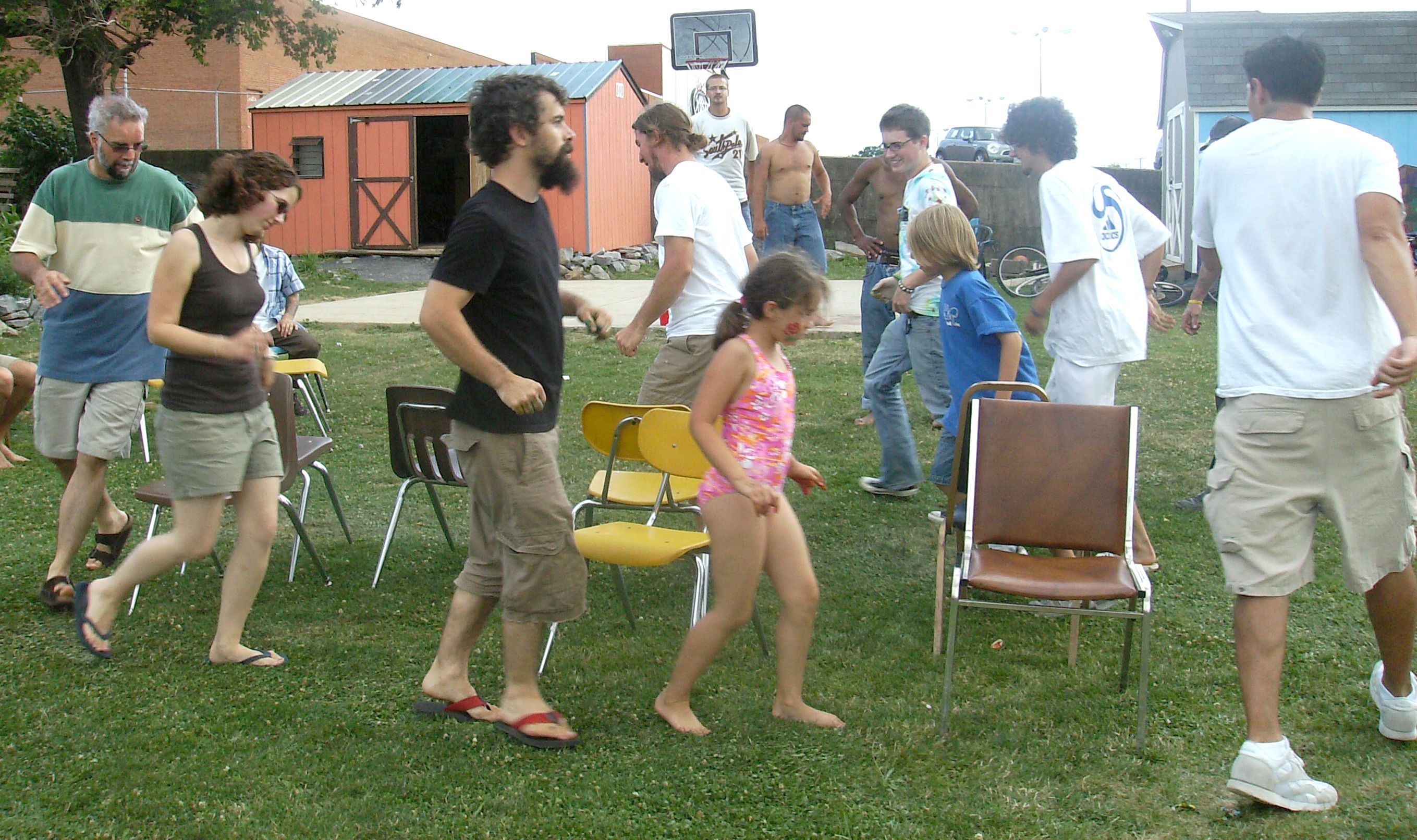 A game of musical chairs being played at a party.