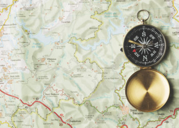 Navigational compass on a map background