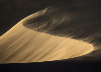 Sand blowing off a sand dune.