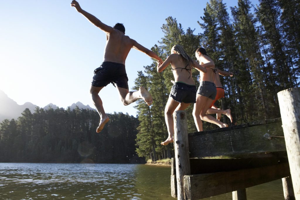 holding hands jumping off a dock