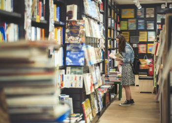 Female student searching for books in the book store