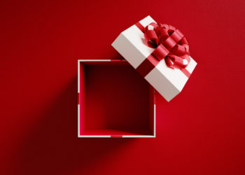 Open white gift box tied with red ribbon