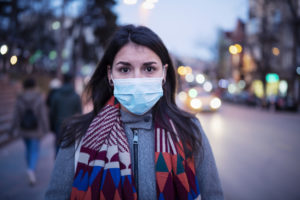 woman on street in protective mask