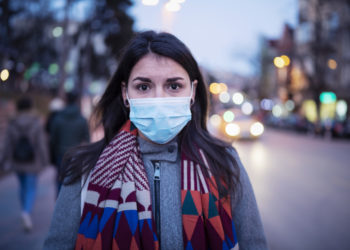 woman on street in protective mask