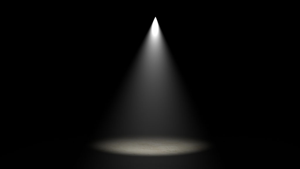 spotlight shining on darkened stage
