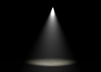 spotlight shining on darkened stage