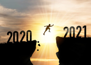 Silhouette Man jumping from 2020 cliff to 2021 cliff