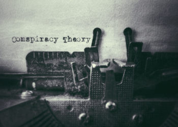 Conspiracy Theory text typed on paper with old typewriter