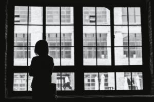 silhouette of person in front of window