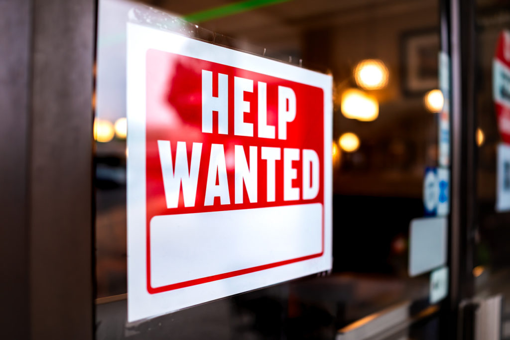 help wanted sign in shop window