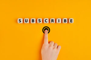 hand pushing a button labeled "subscribe"