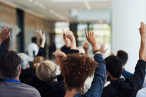 raised hands at a non-virtual meeting