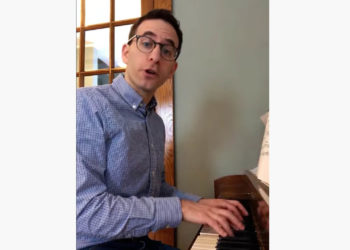 author singing at a piano