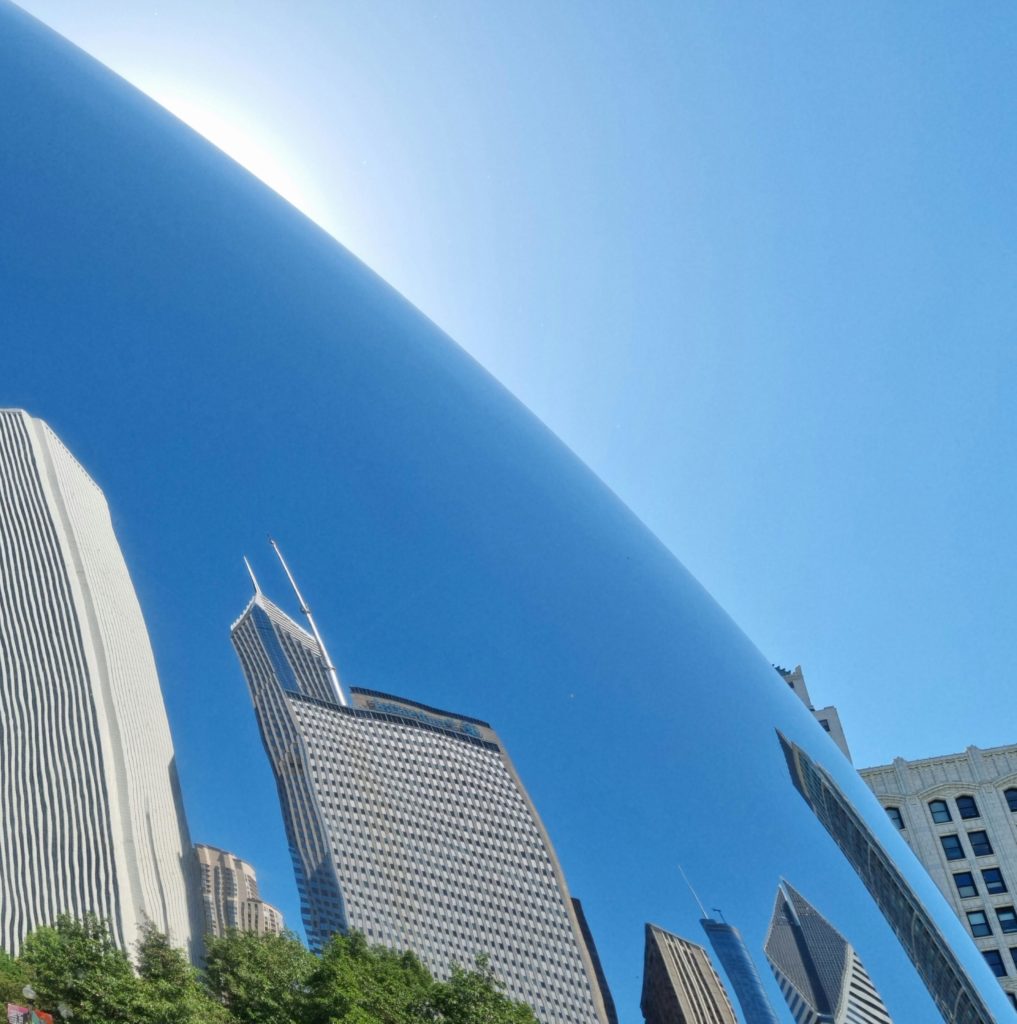 Chicago Architecture reflected in the Cloud Gate sculpture at Millennium Park on a sunny day