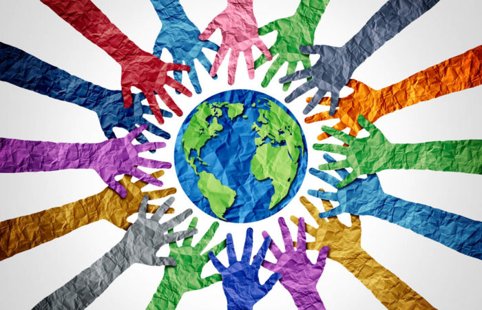 global diversity concept showing diverse hands holding together the planet.