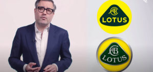 screen grab showing commentator and old complex Lotus logo and new simplified logo