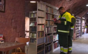 sanitation workers browse books in free library