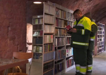 sanitation workers browse books in free library