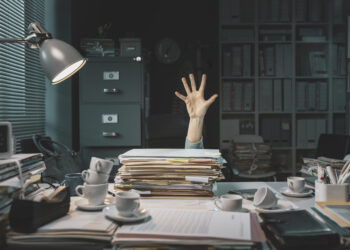 office worker overwhelmed with paperwork