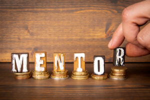 alphabet letter blocks spelling out the word "mentor"