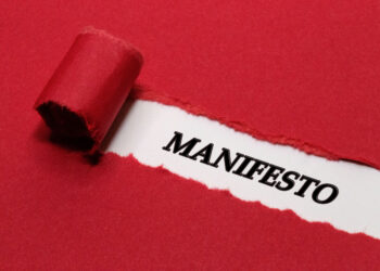 The word Manifesto Written Under Red Torn Paper