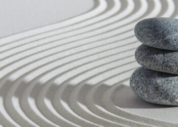 Japanese zen garden with stone and textured sand