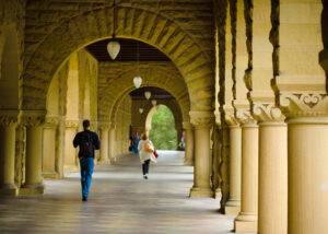 Students walk along covered footpath at Stanford University