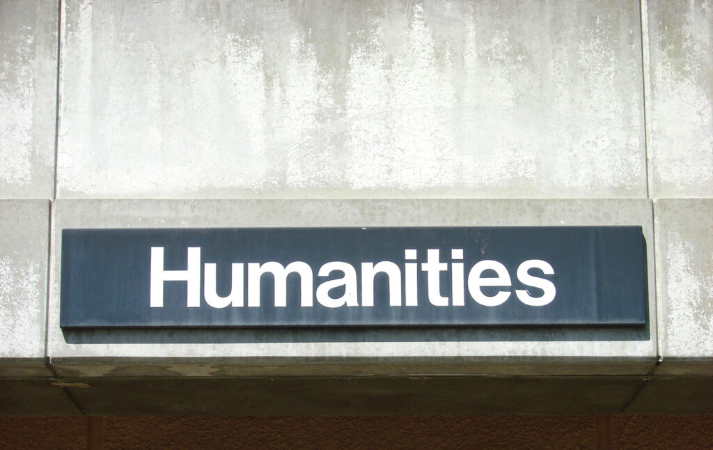 sign reading "humanities" on a concrete wall
