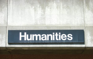 sign reading "humanities" on a concrete wall