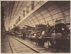Old photograph of a hall filled with large machinery in the mid 1800s