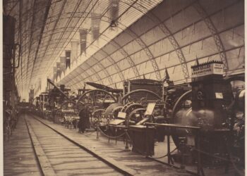 Old photograph of a hall filled with large machinery in the mid 1800s