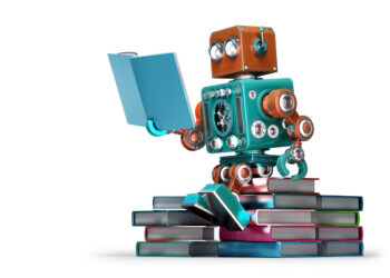Toy robot reading a book