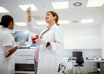 Scientist workin in a laboratory who appears to be pregnant
