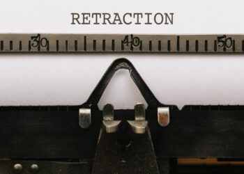 A typewriter with the typed word "Retraction"