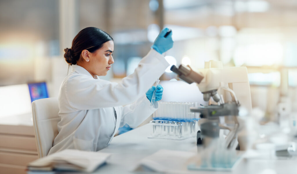 scientist with a pipette and a test tube in a laboratory