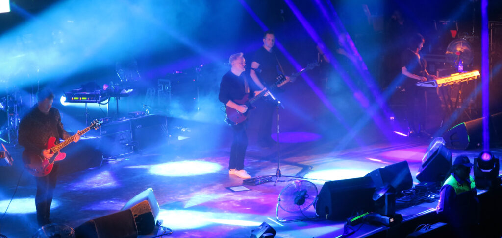 New Order band playing onstage