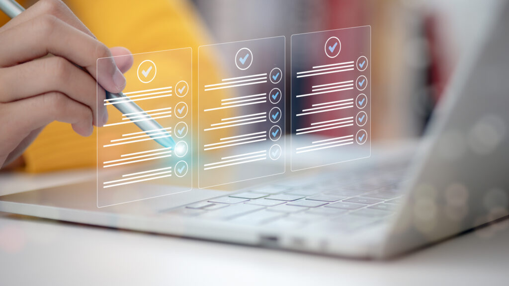 hand touching a virtual screen to tick mark documents for online approval. 