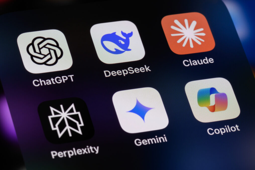 smartphone screen showing various AI apps: ChatGPT, DeepSeek, Anthropic Claude, Perplexity, Google Gemini, Microsoft Copilot.
