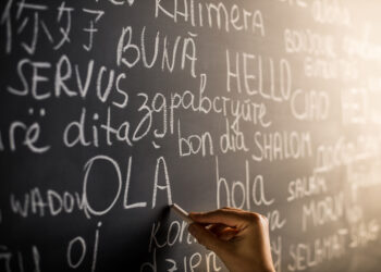 Hello in many languages written with chalk on blackboard