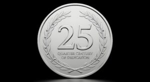 A silver coin on a black background. The coin reads "Celebrating a Quarter Century of Dedication"