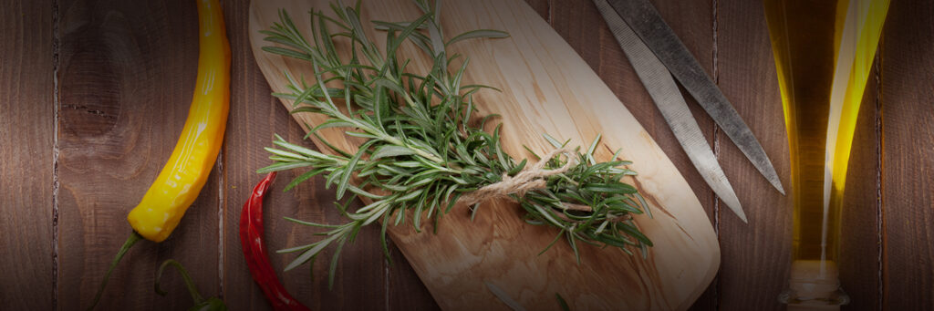 Kitchen counter with herbs, peppers, oil, scissors, cutting board