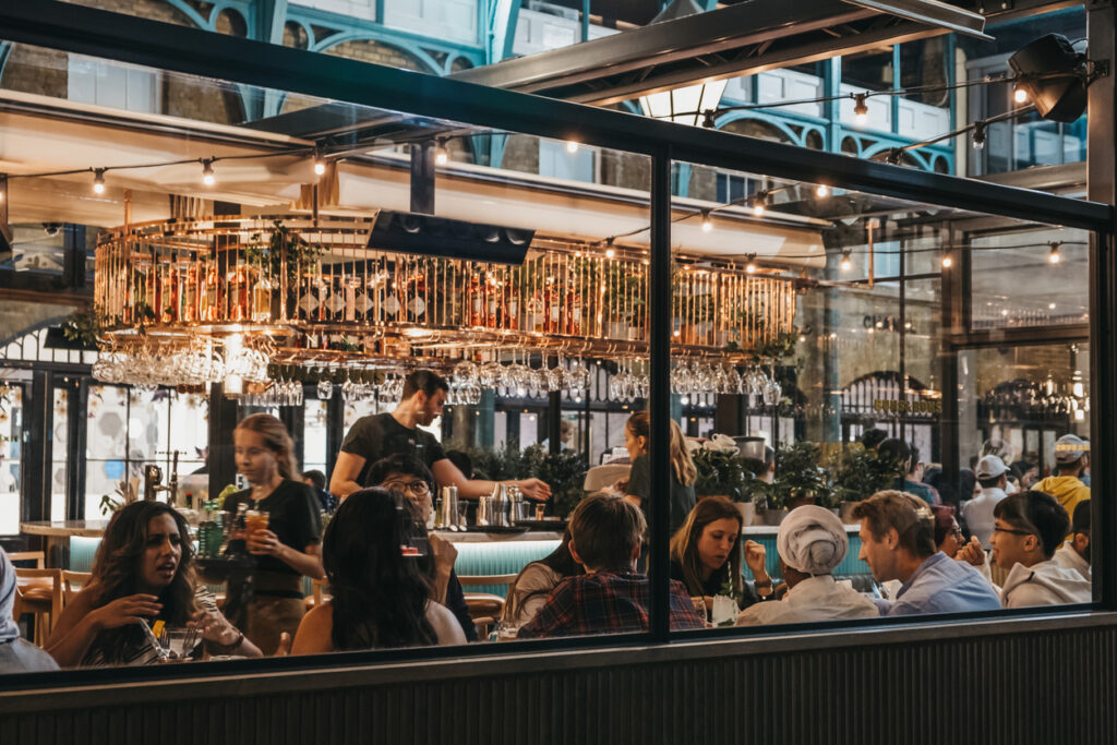 Stock photo of view of busy restaurant through the window of staff and customers inside