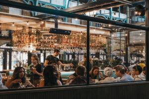 Stock photo of view of busy restaurant through the window of staff and customers inside