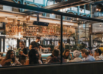 Stock photo of view of busy restaurant through the window of staff and customers inside