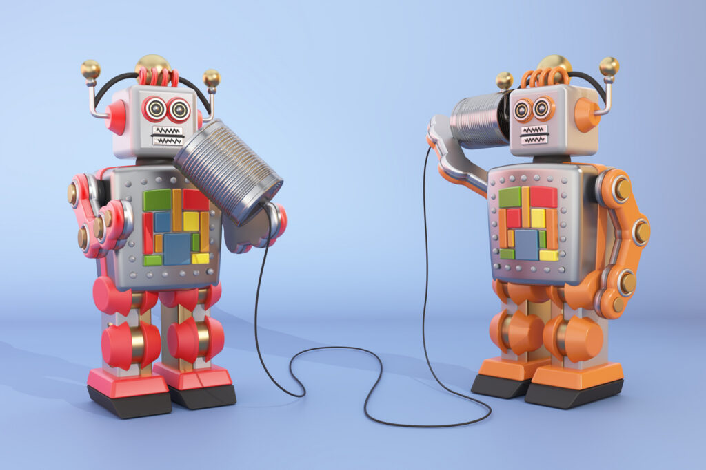 Two colorful toy robots are using tin cans connected by string to communicate 