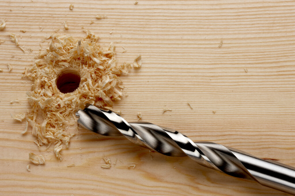 drill bit next to a recently drilled hole