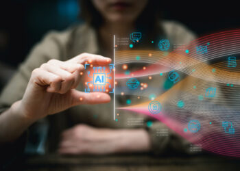 person in the background using their hands to manipulate a superimposed AI icon leading to a flow of various digital icons representing types of information