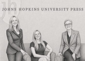 Wendy Queen, Lauren Kane, and Barbara Kline Pope in the lobby of the Johns Hopkins University Press building in Baltimore.