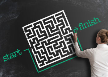 woman bypassing labyrinth by drawing line around it as a workaround on blackboard