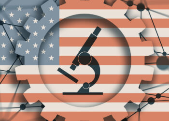 Microscope icon surrounded by gear shapes all on a background of a US flag